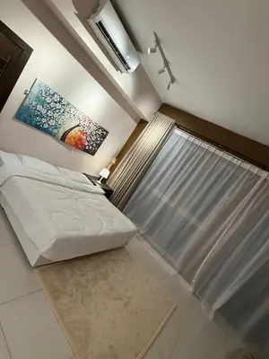 a bedroom with a bed and a painting on the wall at Infinity Sky Pool, Regalia KLCC in Kuala Lumpur