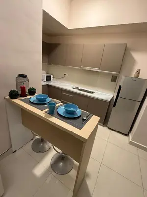a kitchen with a table with blue dishes on it at Infinity Sky Pool, Regalia KLCC in Kuala Lumpur