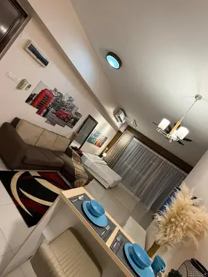 a small living room with a couch and a table at Infinity Sky Pool, Regalia KLCC in Kuala Lumpur