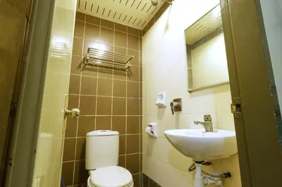 a small bathroom with a toilet and a sink at Nan Yeang Hotel Petaling Street in Kuala Lumpur