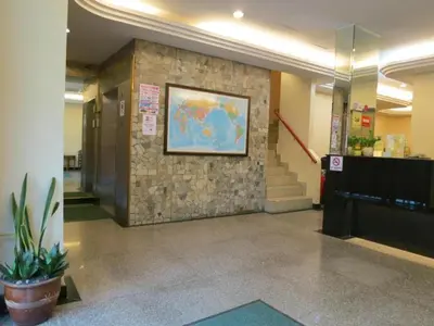 a lobby with a map on a stone wall at Nan Yeang Hotel Petaling Street in Kuala Lumpur