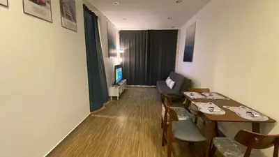 a room with a table and chairs and a television at Setapak Central Mall in Kuala Lumpur