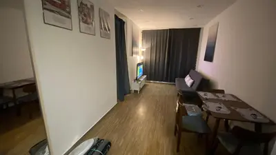 a living room with a table and a couch and a television at Setapak Central Mall in Kuala Lumpur