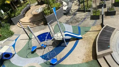 an empty playground with blue chairs and a slide at Setapak Central Mall in Kuala Lumpur