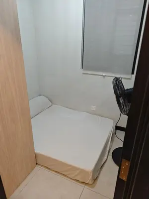 a small room with a bed and a chair at Neu Suite 2 Rooms 1 Bath Unit For Rent Free Wi-Fi Deposit RM200 in Kuala Lumpur