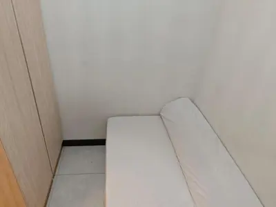 a white couch in a corner of a room at Neu Suite 2 Rooms 1 Bath Unit For Rent Free Wi-Fi Deposit RM200 in Kuala Lumpur
