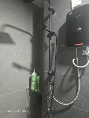 a shower in a bathroom with a blow dryer at Neu Suite 2 Rooms 1 Bath Unit For Rent Free Wi-Fi Deposit RM200 in Kuala Lumpur