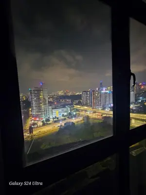 a view from a window of a city at night at Neu Suite 2 Rooms 1 Bath Unit For Rent Free Wi-Fi Deposit RM200 in Kuala Lumpur