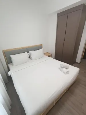 a large white bed in a room with at Agile bukit bintang TRX by KLCC in Kuala Lumpur