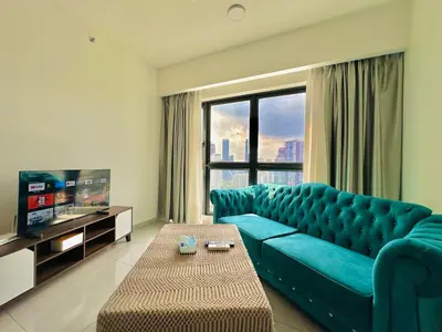 a living room with a blue couch and a tv at Agile bukit bintang TRX by KLCC in Kuala Lumpur