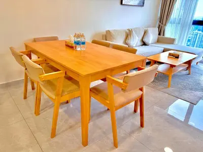 a wooden dining room table with chairs and a couch at Agile Bukit Bintang By AR in Kuala Lumpur
