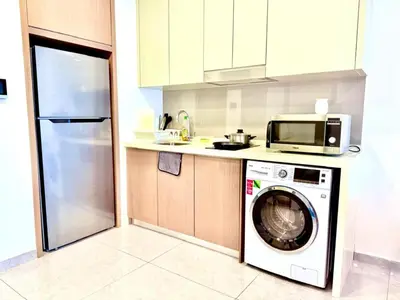 a kitchen with a washing machine and a microwave at Agile Bukit Bintang By AR in Kuala Lumpur