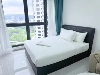 a bed in a room with a large window at Agile Bukit Bintang By AR in Kuala Lumpur
