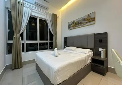 a bedroom with a large bed and a window at K&L Suites Razak City Kuala Lumpur in Kuala Lumpur