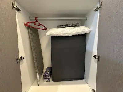 a black closet with a bed and a hanger at K&L Suites Razak City Kuala Lumpur in Kuala Lumpur