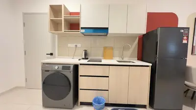 a small kitchen with a refrigerator and a dishwasher at Luxury studio 2607B for couple Majestic Residence KLCC in Kuala Lumpur