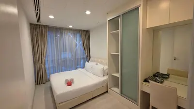 a bedroom with a white bed and a window at KLCC Binjai 8 Premium Soho Apartment by prime suites in Kuala Lumpur