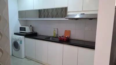 a kitchen with a sink and a washing machine at KLCC Binjai 8 Premium Soho Apartment by prime suites in Kuala Lumpur