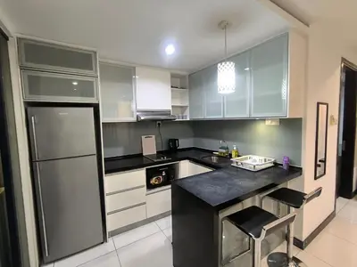 a kitchen with white cabinets and a black counter top at 013A2 Casa Residency- Sweet Home 2R 2B in Kuala Lumpur