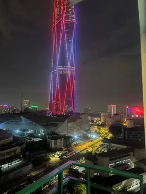 a tall tower lit up in red and blue at night at 013A2 Casa Residency- Sweet Home 2R 2B in Kuala Lumpur