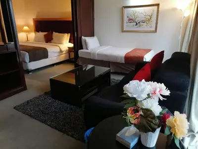 a hotel room with a couch and a bed at KL City Tour Residence Berjaya Times Square in Kuala Lumpur