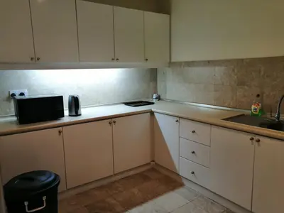 a small kitchen with white cabinets and a sink at KL City Tour Residence Berjaya Times Square in Kuala Lumpur