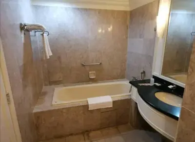 a bathroom with a tub and a sink at KL City Tour Residence Berjaya Times Square in Kuala Lumpur