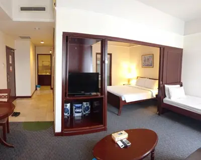 a hotel room with a bed and a television at KL City Tour Residence Berjaya Times Square in Kuala Lumpur
