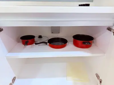 three pots and pans on a stove in a kitchen at Platinum Suites Kuala Lumpur BY NOVA in Kuala Lumpur