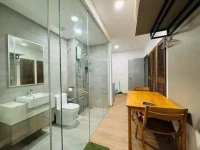 a bathroom with a sink and a toilet and a table at Riveria city in Kuala Lumpur