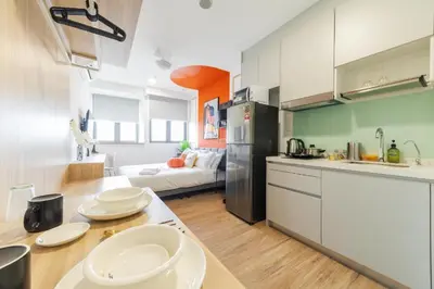a kitchen with a table with plates on it at Riveria city in Kuala Lumpur