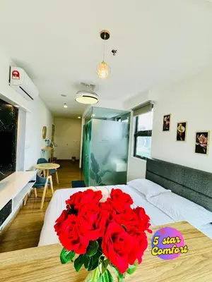 a bouquet of red roses in a vase on a bed at Riveria city in Kuala Lumpur