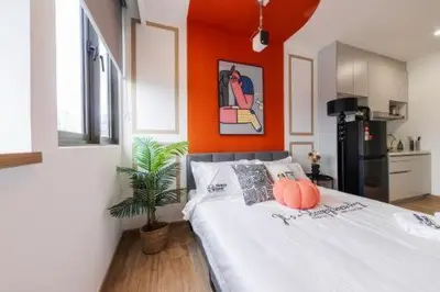 a bedroom with a bed with two pumpkins on it at Riveria city in Kuala Lumpur