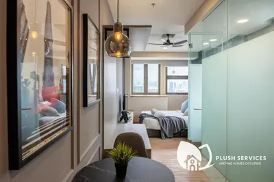 a living room with a table and a bedroom at Riveria city in Kuala Lumpur