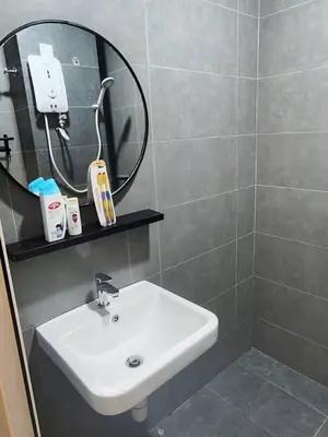 a bathroom with a sink and a mirror at Mini studio with own private bathroom, free Wi-Fi in Kuala Lumpur