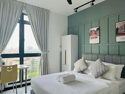 a bedroom with a large bed and a window at Neu suite, Family Unit - Jelatek LRT Gleneagles Hospital in Kuala Lumpur