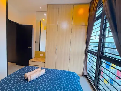 a bedroom with a blue bed and a large window at Neu suite, Family Unit - Jelatek LRT Gleneagles Hospital in Kuala Lumpur