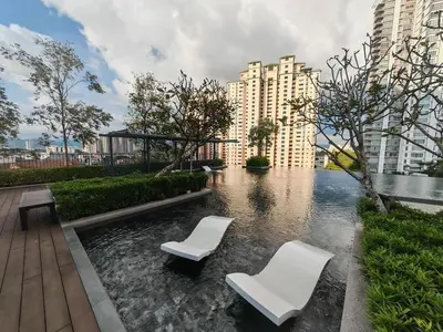 two white chairs sitting in a pond in a city at 1-4pax, Spacious Studio, Jalan Ipoh KL The Pano in Kuala Lumpur