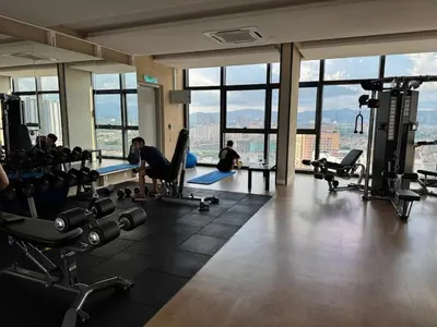 a gym with people working out in a building with windows at 1-4pax, Spacious Studio, Jalan Ipoh KL The Pano in Kuala Lumpur