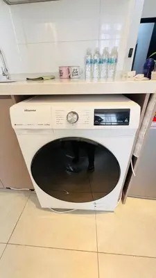a white microwave sitting on the floor in a kitchen at Butterfly Home in Kuala Lumpur