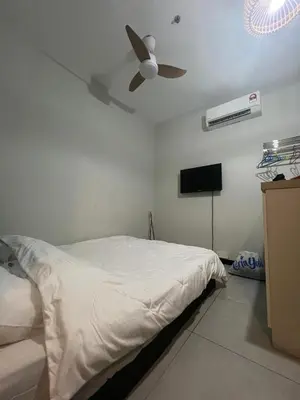 a bedroom with a bed and a ceiling fan at Neu Suite small studio with own private bathroom free wifi Deposit RM200 in Kuala Lumpur