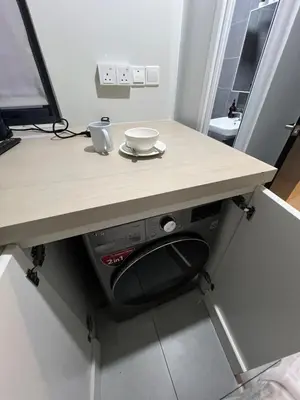 a table with a chair under a counter with a bowl on it at Neu Suite small studio with own private bathroom free wifi Deposit RM200 in Kuala Lumpur