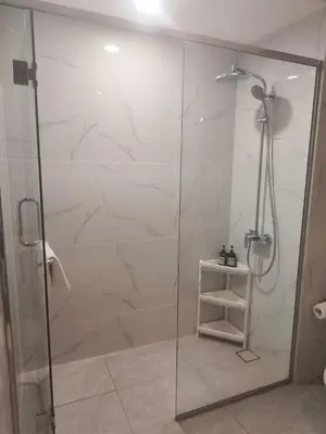 a shower with a glass door in a bathroom at Sky Line Agile Suites KL in Kuala Lumpur