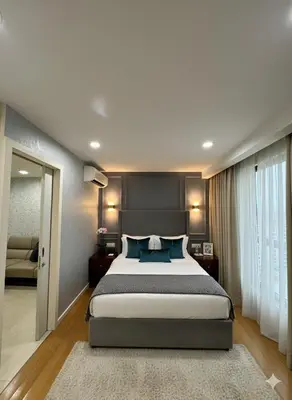 a bedroom with a large bed with blue pillows at Luxury Fairlane Residence Suites Kuala Lumpur by AZI BNB in Kuala Lumpur
