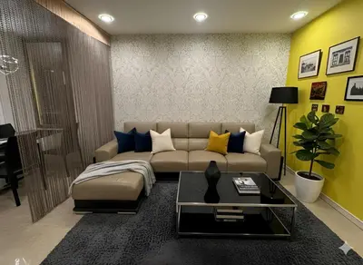 a living room with a couch and a table at Luxury Fairlane Residence Suites Kuala Lumpur by AZI BNB in Kuala Lumpur
