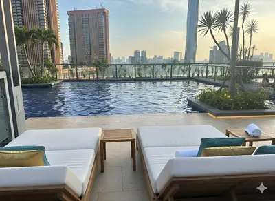 a swimming pool with two couches and a view of the city at Luxury Fairlane Residence Suites Kuala Lumpur by AZI BNB in Kuala Lumpur
