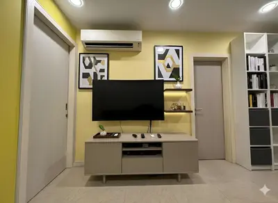 a living room with a flat screen tv on the wall at Luxury Fairlane Residence Suites Kuala Lumpur by AZI BNB in Kuala Lumpur