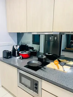 a kitchen with a counter top with pots and pans at FA Suits KL BY ROBERTSON in Kuala Lumpur