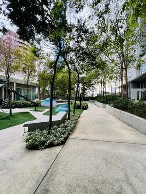 a park with a bench and trees on a sidewalk at FA Suits KL BY ROBERTSON in Kuala Lumpur