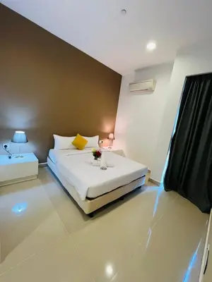 a bedroom with a large white bed with flowers on it at The platinum KLCC by suites hospitality in Kuala Lumpur